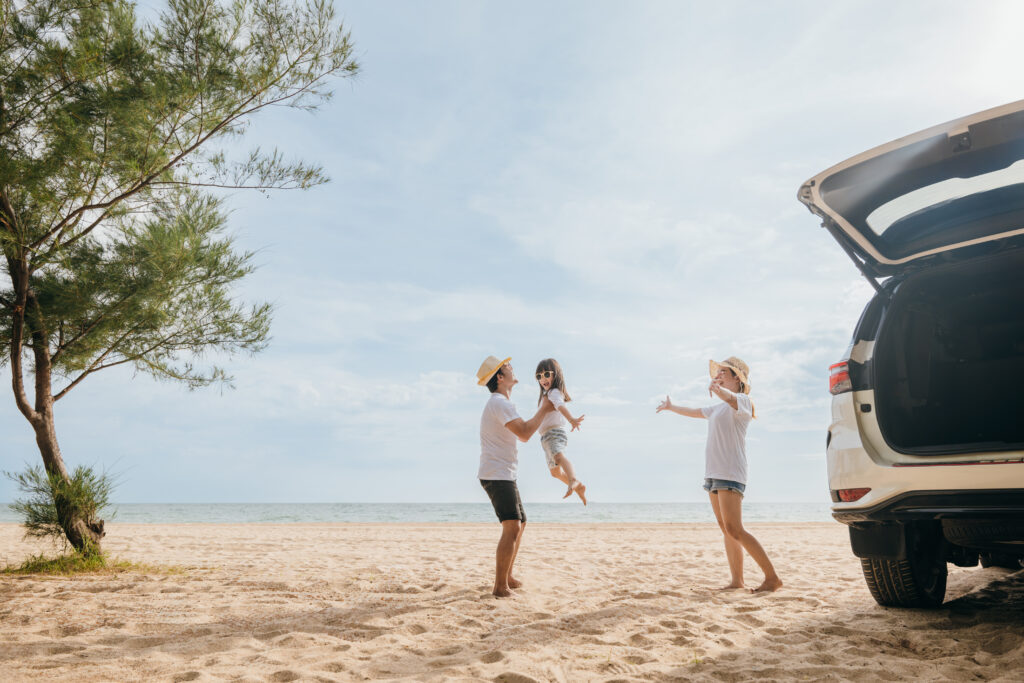 happy family three playing on beach, parents father holding child on his shoulders jump a child fly to air, holiday vacations summer road trip, back car, family day enjoying their time