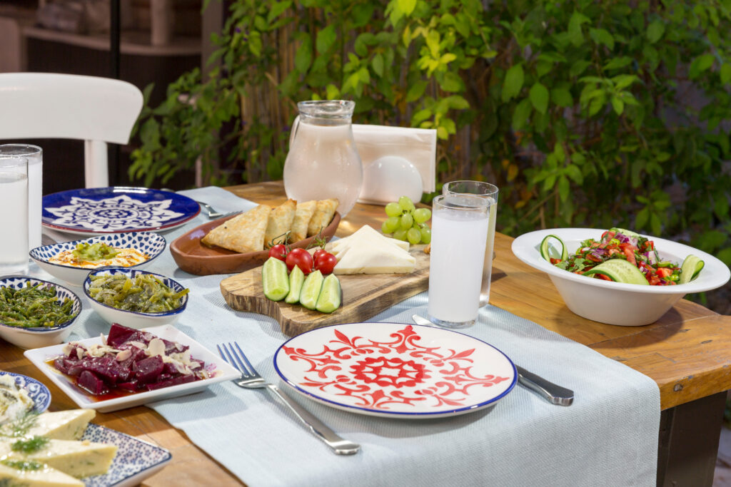 Lesvos Gastronomy Guide: The Best Tavernas and Local Delicacies luxury,table,with,plate,of,fish,,meat,,pickles,,antipasto,,aubergine,