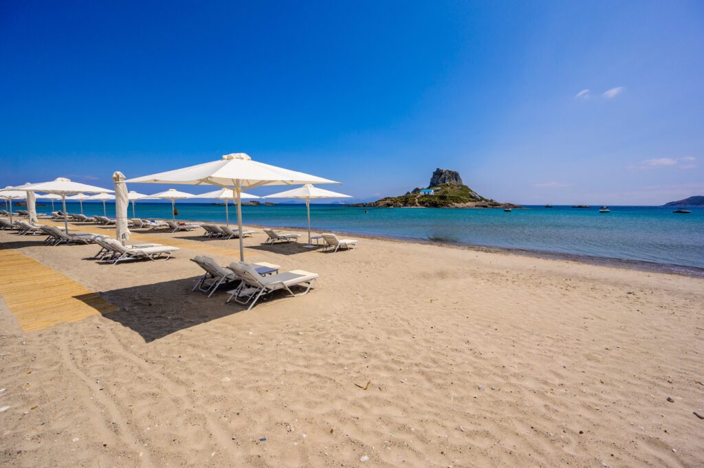 deck,chair,and,umbrella,on,beautiful,agios,stefanos,beach,in