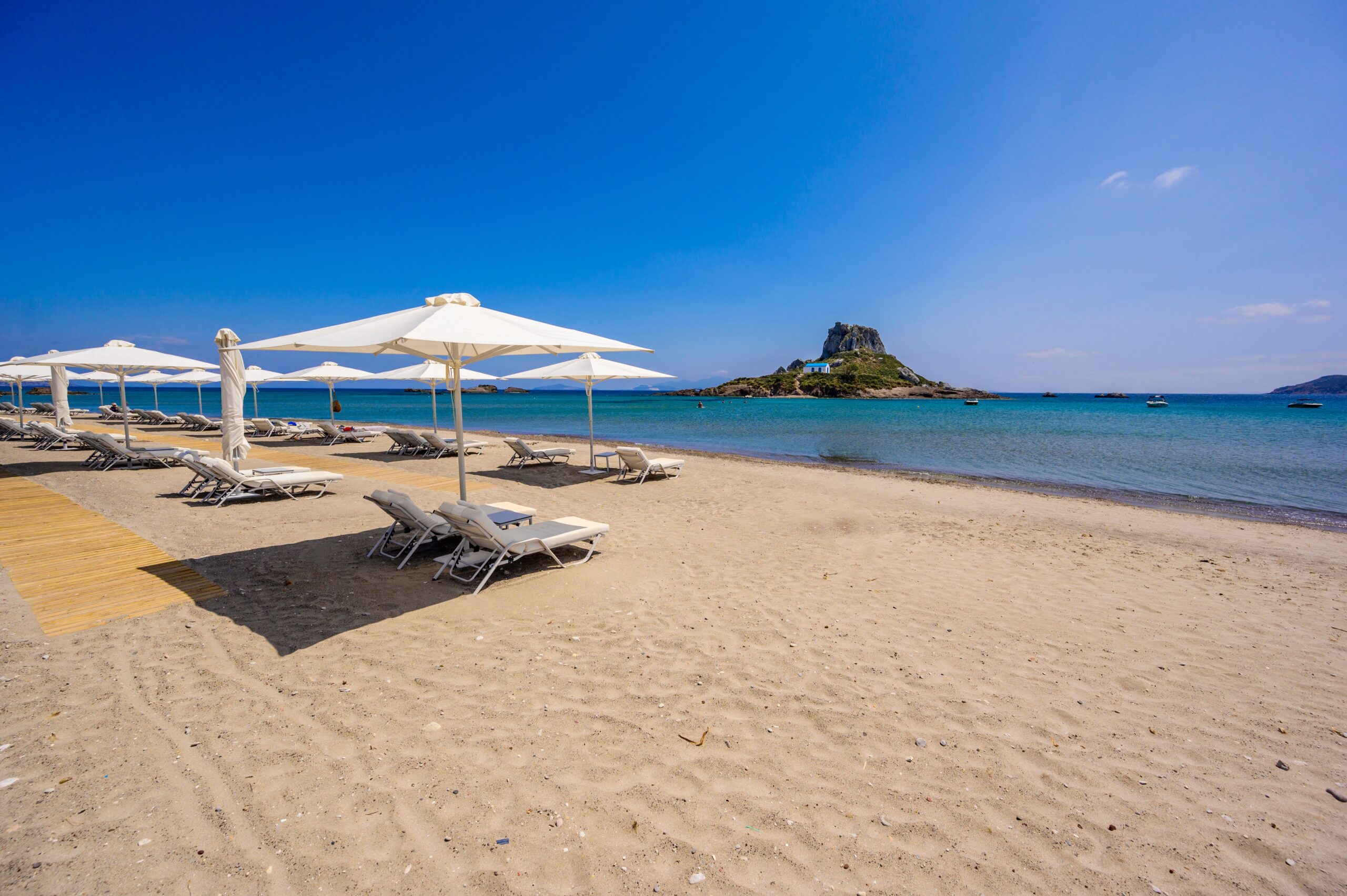 deck,chair,and,umbrella,on,beautiful,agios,stefanos,beach,in