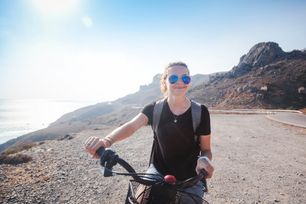 young,beautiful,girl,woman,travels,by,bicycle,on,a,mountain