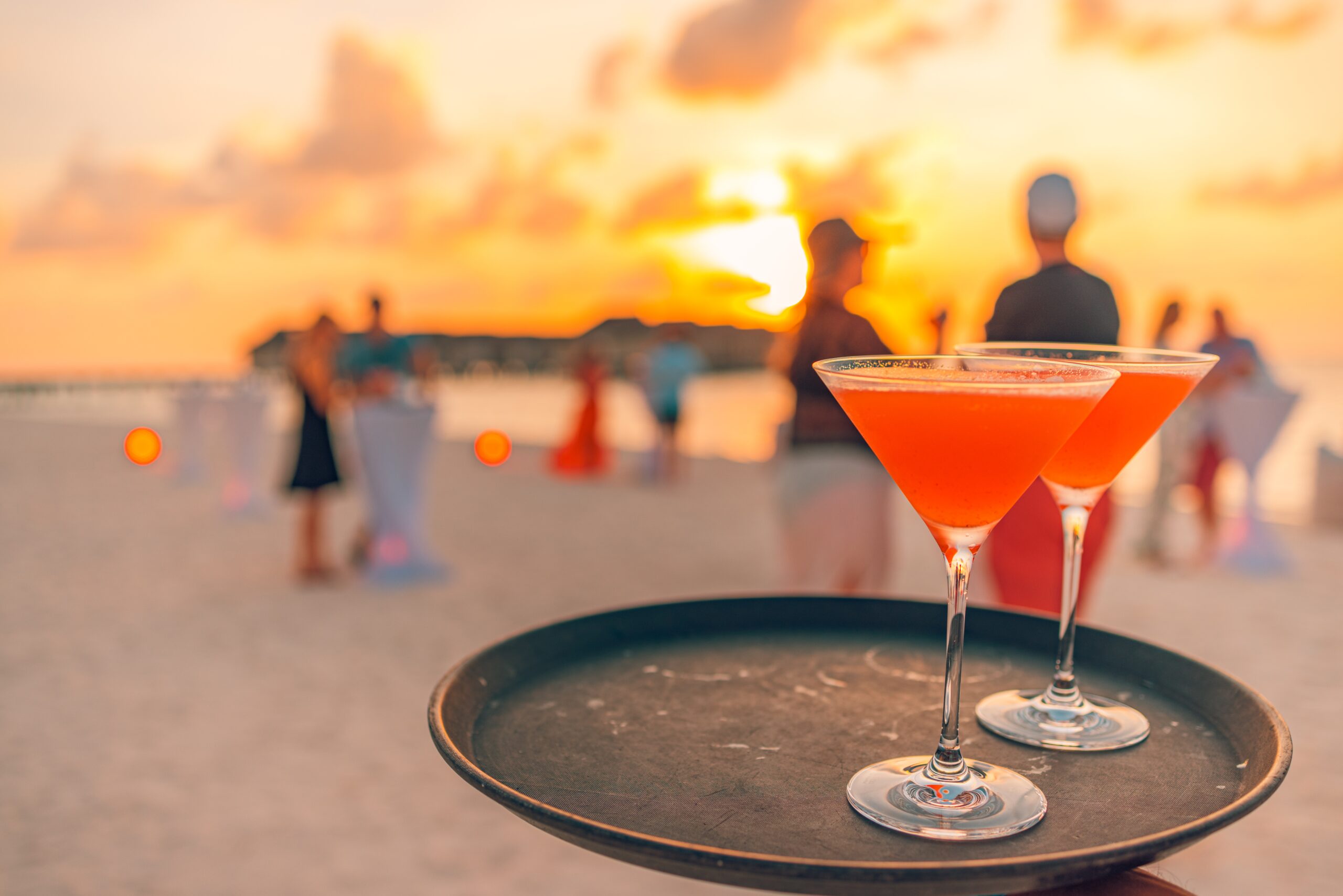 two,cocktail,drinks,with,blur,beach,party,people,and,colorful