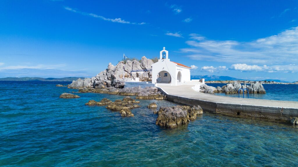 aerial,drone,view,of,agios,isidoros,chapel,on,a,rocky